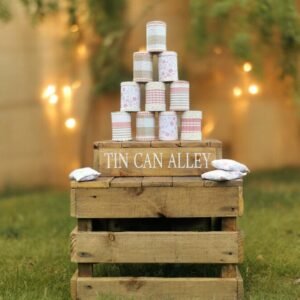 tin can alley wedding game with bean bags on top of a rustic crate