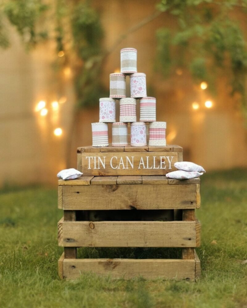 tin can alley wedding game with bean bags on top of a rustic crate