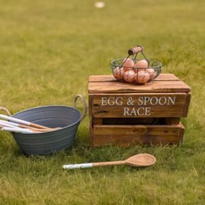 rustic boho style egg and spoon race wedding game on a crate