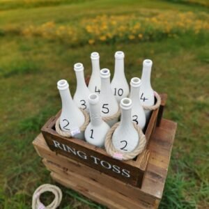 rustic style ring toss wedding game with white bottles and just rope rings