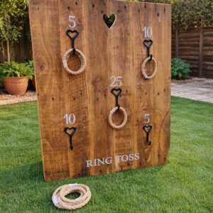 Rustic wooden ring toss wall garden game hire, popular outdoor wedding and party entertainment.